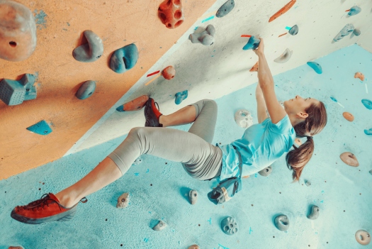 Young woman training in climbing gym